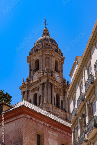 Malaga, Spain - August 06, 2024: Church tower of the Malaga Cathedral or the Santa Iglesia Catedral Basílica de la Encarnación photo