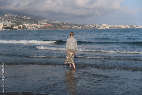 Woman taking a walk in the mediterranean sea photo