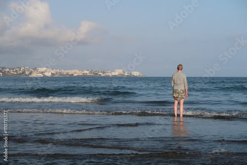 Woman taking a walk in the mediterranean sea photo