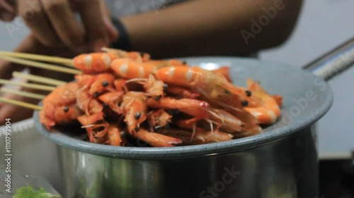 One speared a prawn. Prawn satay dish