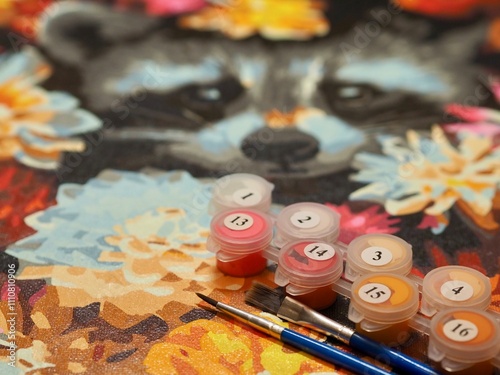 Fototapeta Naklejka Na Ścianę i Meble -  A paint by numbers kit showcases vibrant colors, brushes, and numbered paint pots on a partially completed canvas, offering a creative and relaxing activity.