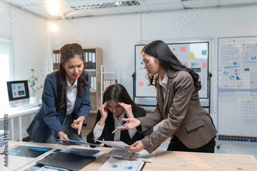 Two businesswomen arguing and complaining with a stressed colleague about project failure, showing their disagreement and concern about the bad results in the company office