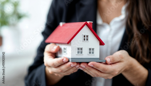 Hands Holding Miniature House Representing Real Estate Investment Opportunities