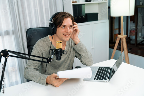 Εκτύπωση καμβά Host channel in smart broadcaster with talking show on live social media streaming with script note reading to listeners, wearing headphones to record video streamer at modern home studio
