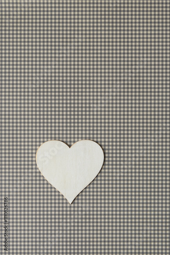 laser-cut wooden heart shape on green plaid scrapbooking paper