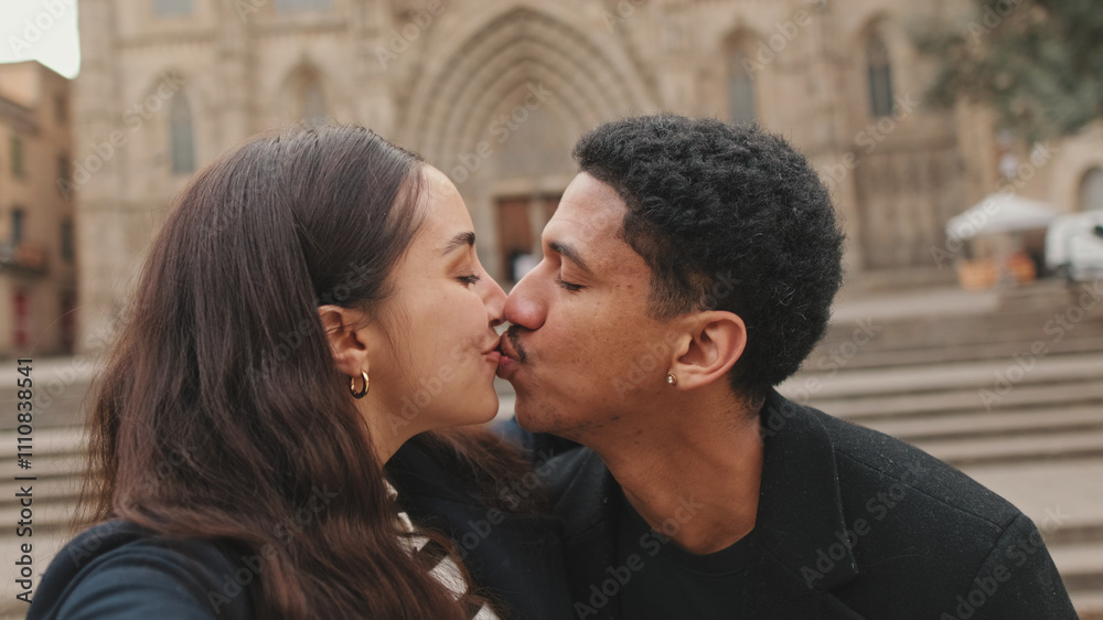 Happy couple standing and kissing in front of historic cathedral, showcasing travel and relationships Happy couple standing and kissing in front of historic cathedral, showcasing travel and relationships
