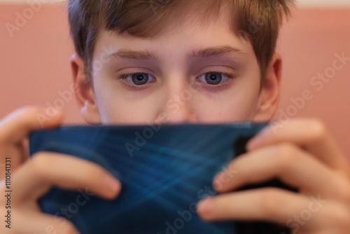 Close-up of a teenager's eyes staring at a smartphone