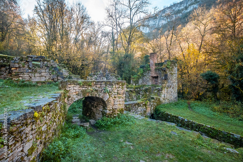 Ruins of Moulin du Tournefeuille, an abandoned 18th century water mill, near Grammat on the Alzou river in the Lot region of France photo