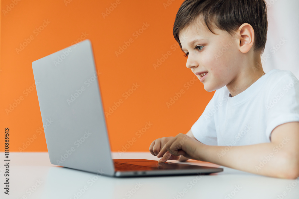 Boy Studying Playing On Laptop Online At Table Boy Studying Playing On Laptop Online At Table