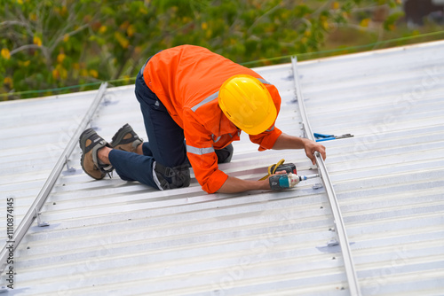 Men technicians mounting photovoltaic solar moduls on roof of house. photo