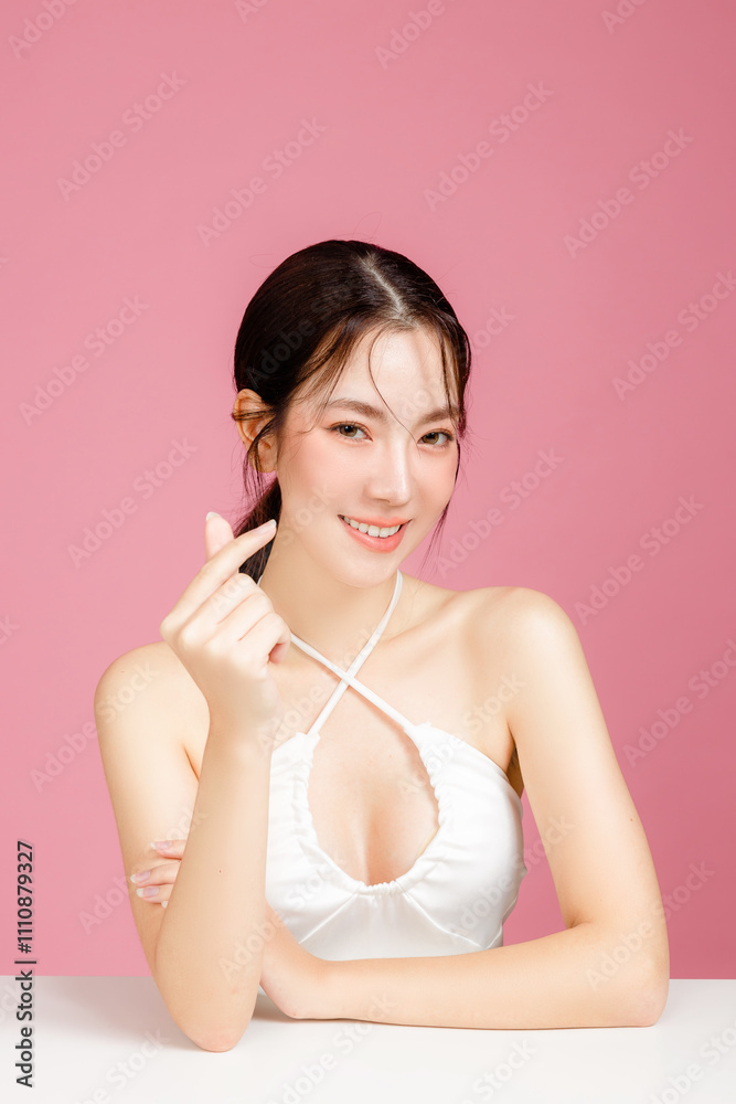 Young Asian woman gathered in ponytail with natural makeup on face have plump lips and clean fresh skin wearing white camisole showing Young Asian woman gathered in ponytail with natural makeup on face have plump lips and clean fresh skin wearing white camisole showing
