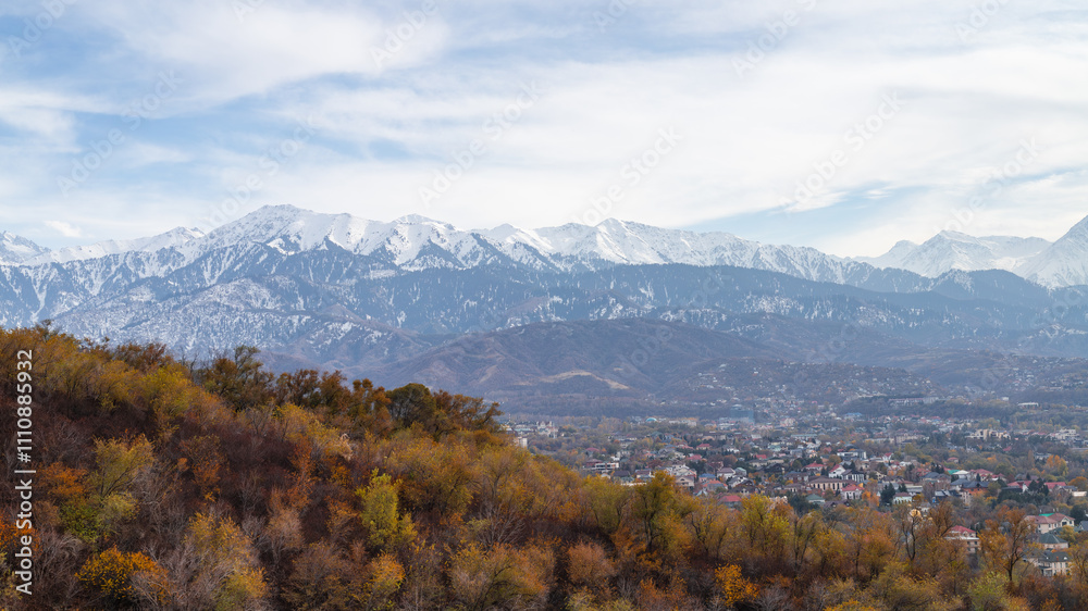 Village in valley with snow-capped mountains, autumn trees, and serene atmosphere. Village in valley with snow-capped mountains, autumn trees, and serene atmosphere.