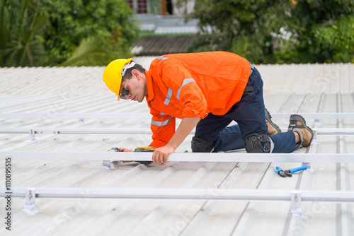 Men technicians mounting photovoltaic solar moduls on roof of house. photo