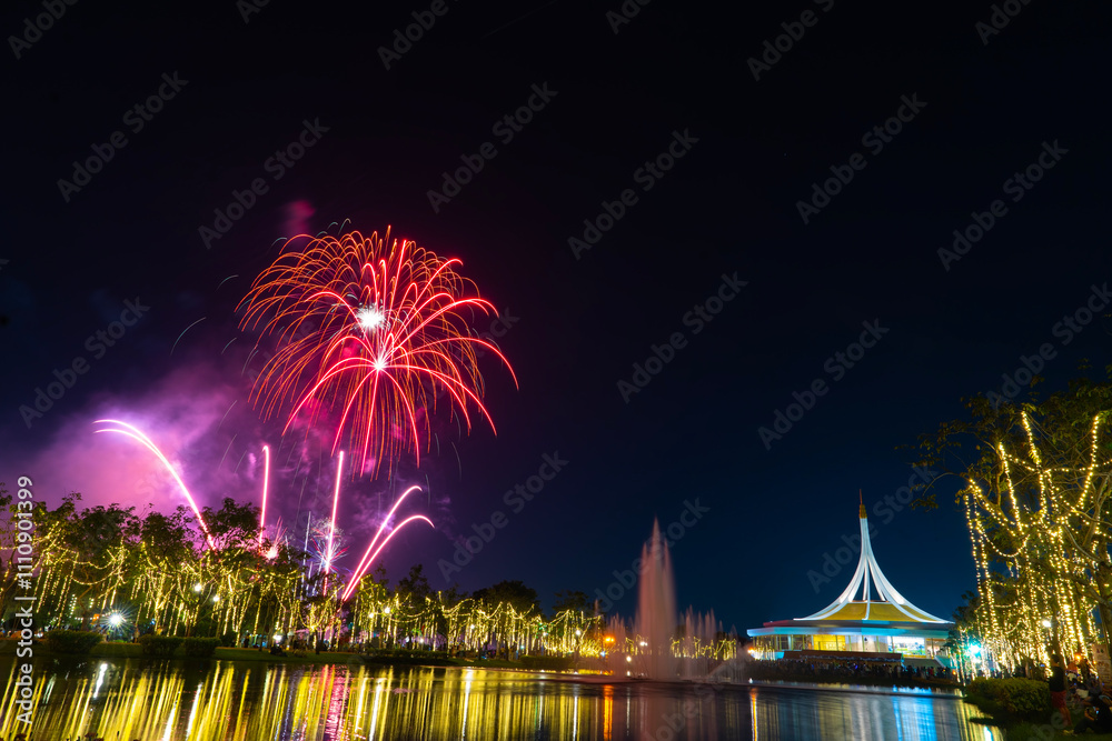 Naklejka premium Colorful fireworks set off at the Royal Park Rajapruek 2024 Flower Festival in Bangkok, Thailand,