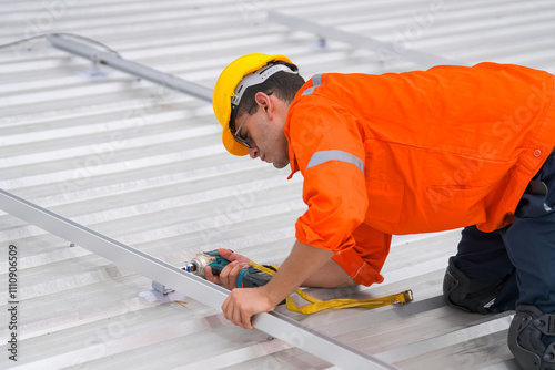 Men technicians mounting photovoltaic solar moduls on roof of house. photo