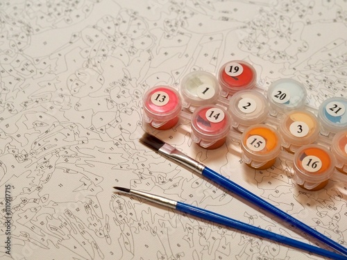 An intricate paint by numbers canvas accompanied by labeled paint pots and brushes, designed to guide artists in creating a detailed and satisfying masterpiece.