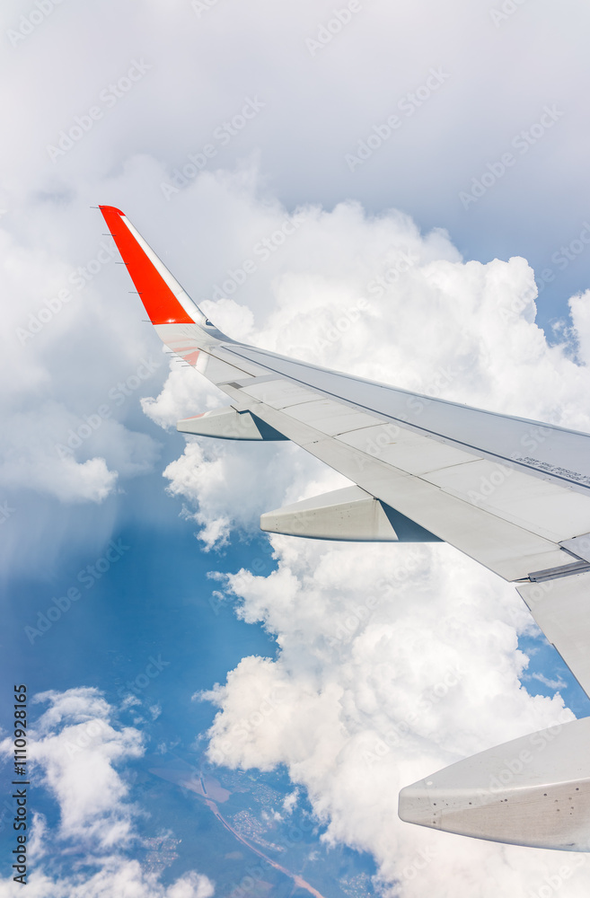 View from the airplane window at a beautiful cloudy sky and the airplane wing View from the airplane window at a beautiful cloudy sky and the airplane wing