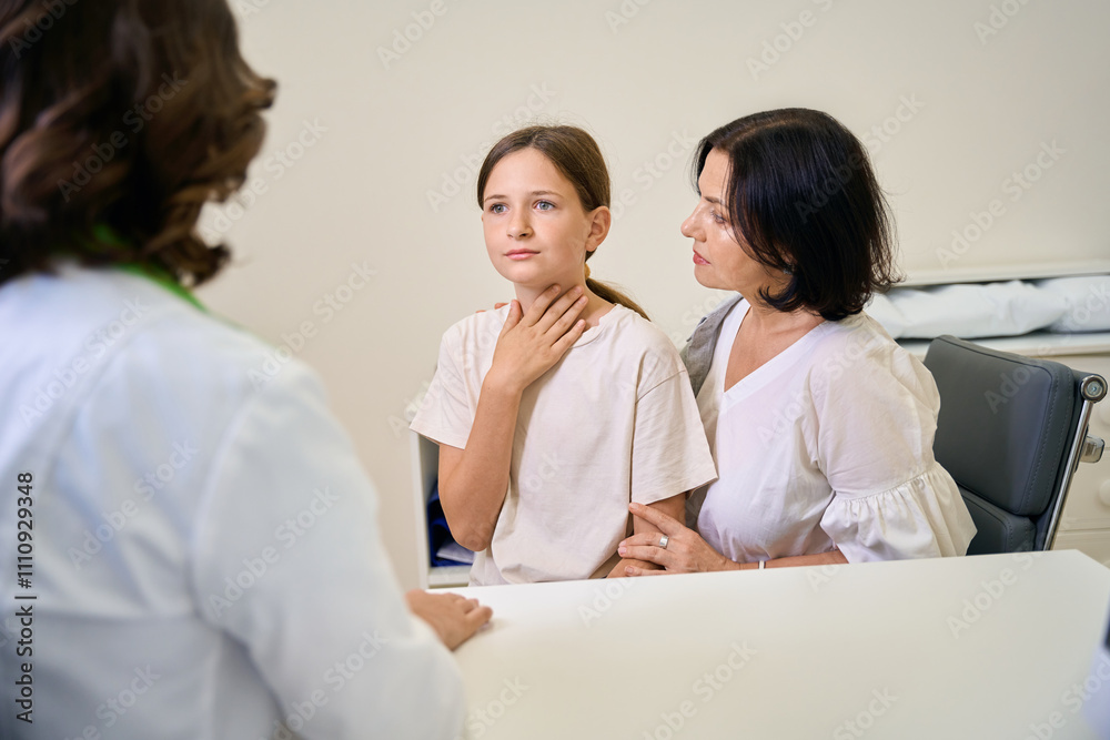 Teenage girl at appointment with pediatrician complains of sore throat Teenage girl at appointment with pediatrician complains of sore throat