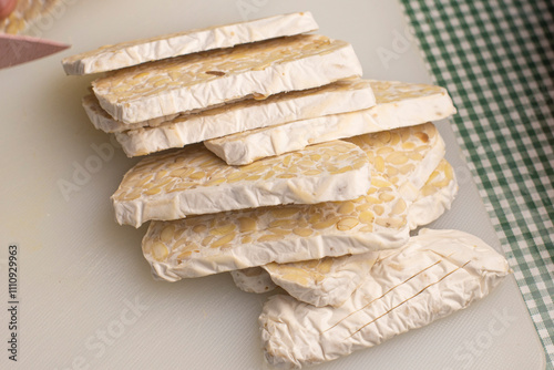 Stack the tempeh slices. Traditional food from fermented soybeans becomes tempeh. photo