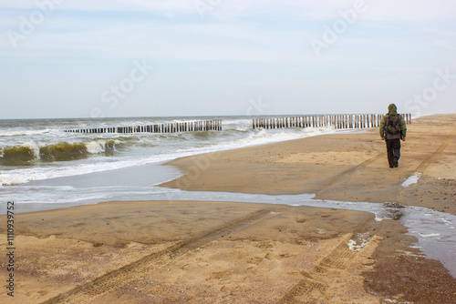 A man on the beach in Renesse, Zeeland, the Netherlands photo