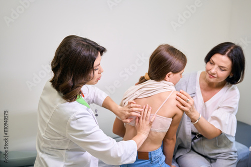 Young doctor taps a patients back photo