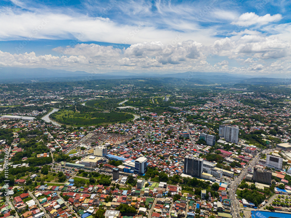 Beautiful blue sky and clouds above in Davao City. Eagle aerial view of River and cityscape of Davao City. Mindanao, Philippines. Beautiful blue sky and clouds above in Davao City. Eagle aerial view of River and cityscape of Davao City. Mindanao, Philippines.
