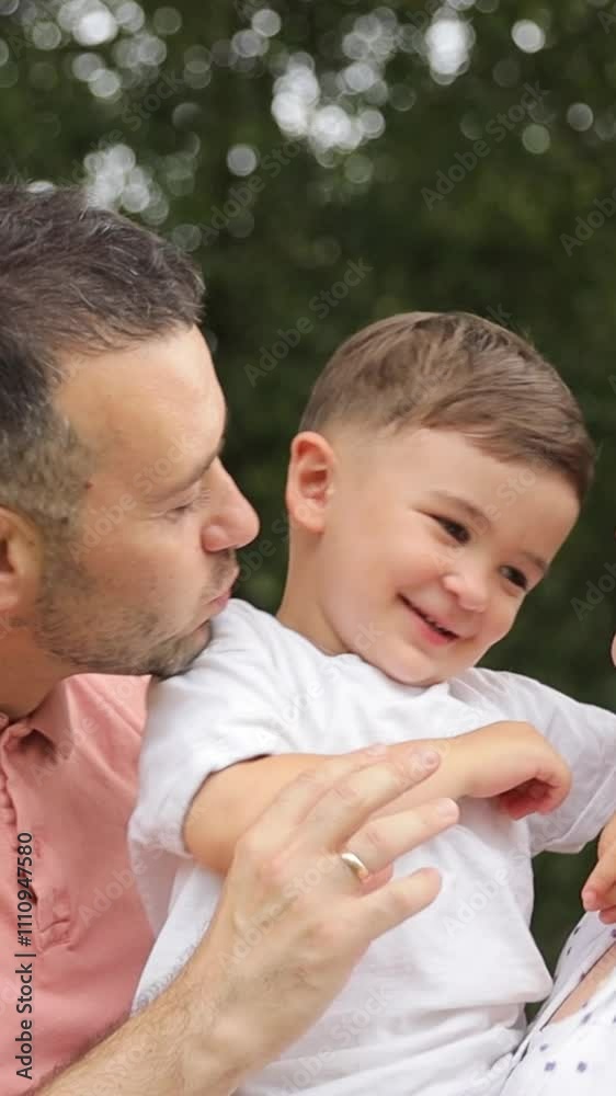 Vertical video a happy family resting outdoors in summer Vertical video a happy family resting outdoors in summer