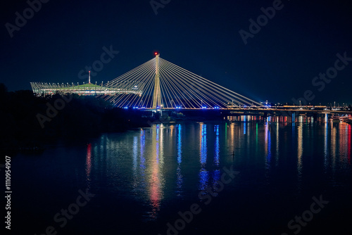 Beautiful panoramic night aerial view from drone of Narodowy Stadium - panorama with reflection in Vistula river, Warsaw, Poland, EU.