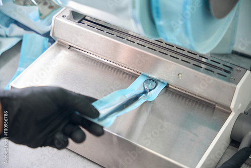 Canvas Print Dentist using packaging machine to hermetically close the sterile tool
