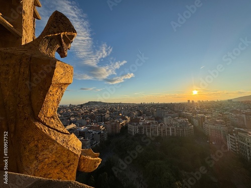 Photography View of Barcelona from the towers of La Sagrada Familia during sunset featuring the architectural details, sculpture, and stonework of the basilica