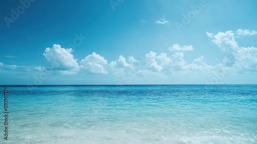 Calm ocean with blue sky and white clouds