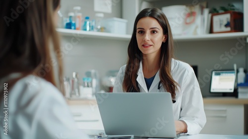 Young female nutritionist talking with patient through laptop computer video call at clinical consultation room. Healthy lifestyle, nutrition and diet concept.