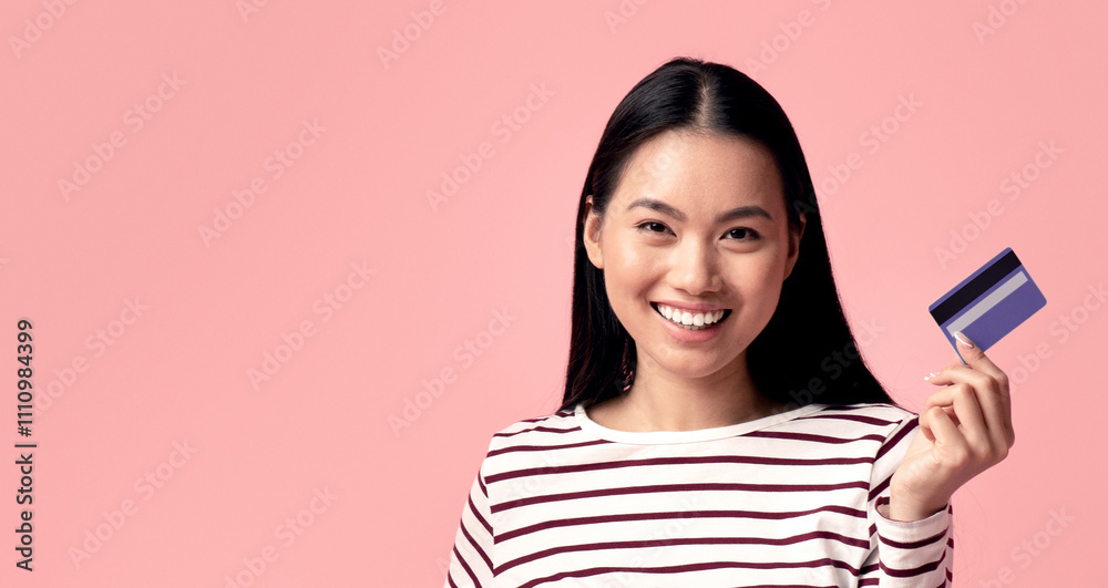 Online Shopping Concept. Cheerful Asian Female Sitting With Laptop And Credit Card Among Bright Shopping Bags Over Pink Studio Background, Happy Korean Female Enjoying Making Pucrhases In Internet Online Shopping Concept. Cheerful Asian Female Sitting With Laptop And Credit Card Among Bright Shopping Bags Over Pink Studio Background, Happy Korean Female Enjoying Making Pucrhases In Internet