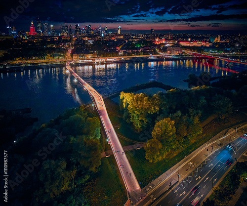 Obraz na płótnie Beautiful panoramic aerial drone night sunset view to the new pedestrian and bicycle bridge connecting the banks of the Vistula, Warsaw, Poland. w salonie