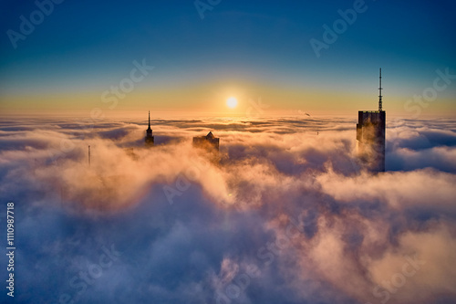 Beautiful panoramic fabulous, mesmerizing, unreal, aerial drone view of skyscrapers sticking out of low fog at sunrise, Warsaw, Poland, EU. VARSO - the tallest skyscraper in EU.