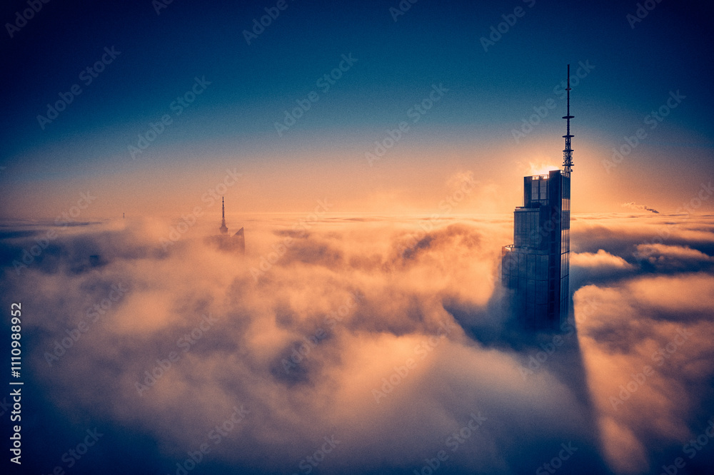 Beautiful panoramic fabulous, mesmerizing, unreal, aerial drone view of skyscrapers sticking out of low fog at sunrise, Warsaw, Poland, EU. VARSO - the tallest skyscraper in EU.