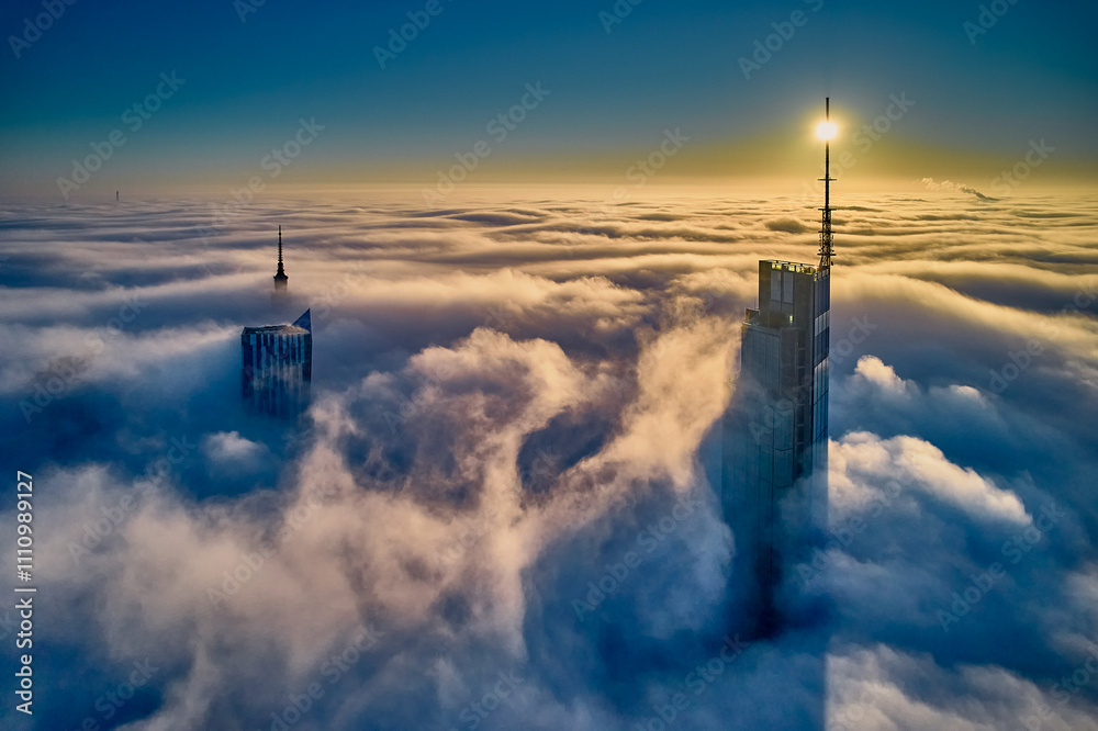 Beautiful panoramic fabulous, mesmerizing, unreal, aerial drone view of skyscrapers sticking out of low fog at sunrise, Warsaw, Poland, EU. VARSO - the tallest skyscraper in EU.