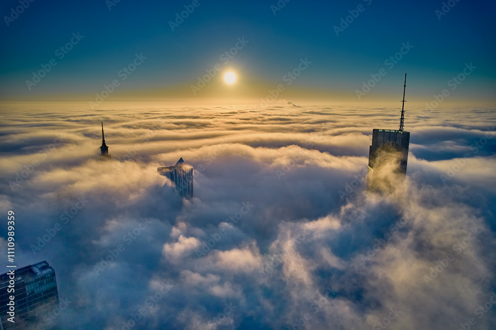 Beautiful panoramic fabulous, mesmerizing, unreal, aerial drone view of skyscrapers sticking out of low fog at sunrise, Warsaw, Poland, EU. VARSO - the tallest skyscraper in EU.