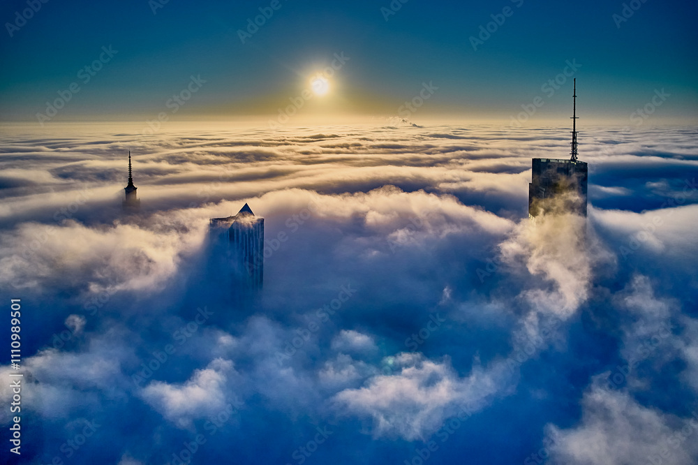 Beautiful panoramic fabulous, mesmerizing, unreal, aerial drone view of skyscrapers sticking out of low fog at sunrise, Warsaw, Poland, EU. VARSO - the tallest skyscraper in EU.