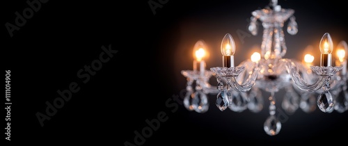 Elegant crystal chandelier illuminating a dark room with warm light