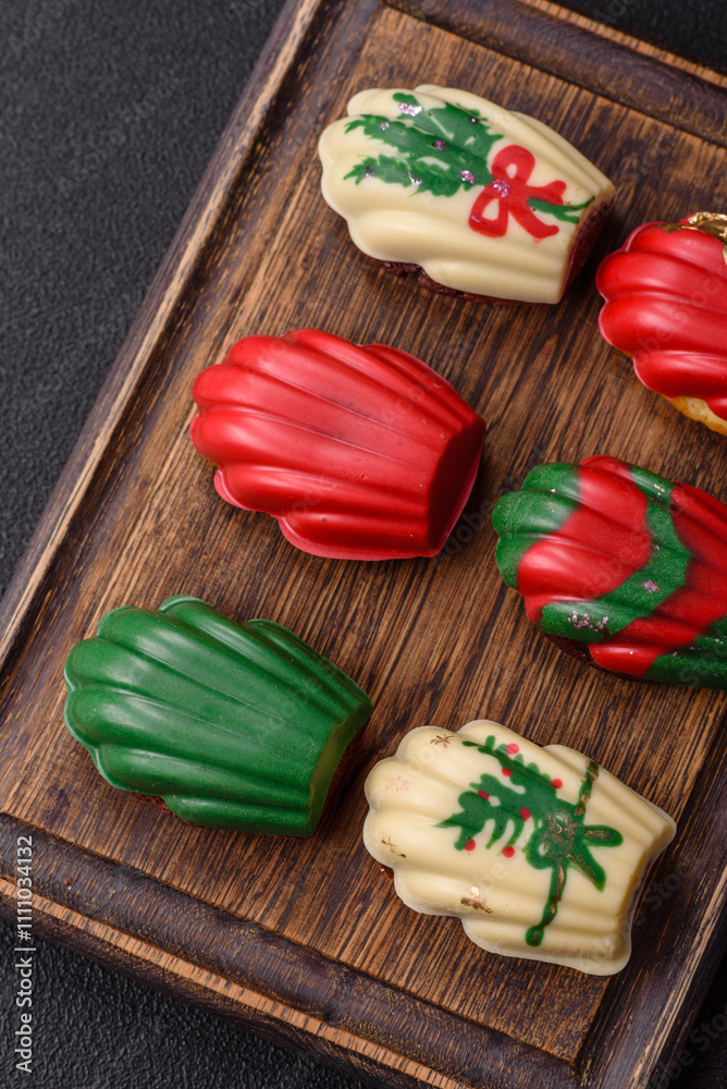 Sweet madeleine sponge cookies covered with colored chocolate Sweet madeleine sponge cookies covered with colored chocolate