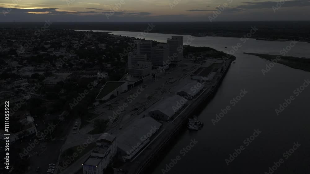 Drone flies over the Puerto de Asuncion toward a cloudy sunset Drone flies over the Puerto de Asuncion toward a cloudy sunset