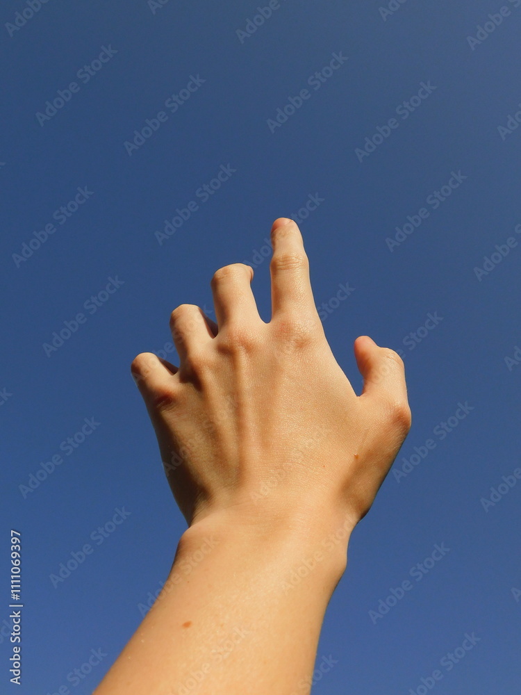 Hand pointing to the blue sky, first person perspective. Hand pointing to the blue sky, first person perspective.