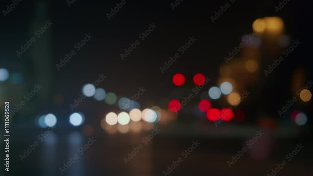 Lights of cars driving in evening city. Defocused headlights and taillights. Moving bokeh circles of cars in night. Blurred city traffic background Lights of cars driving in evening city. Defocused headlights and taillights. Moving bokeh circles of cars in night. Blurred city traffic background