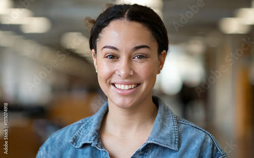 A headshot portrait of a happy, smiling millennial mixed race woman employee or student