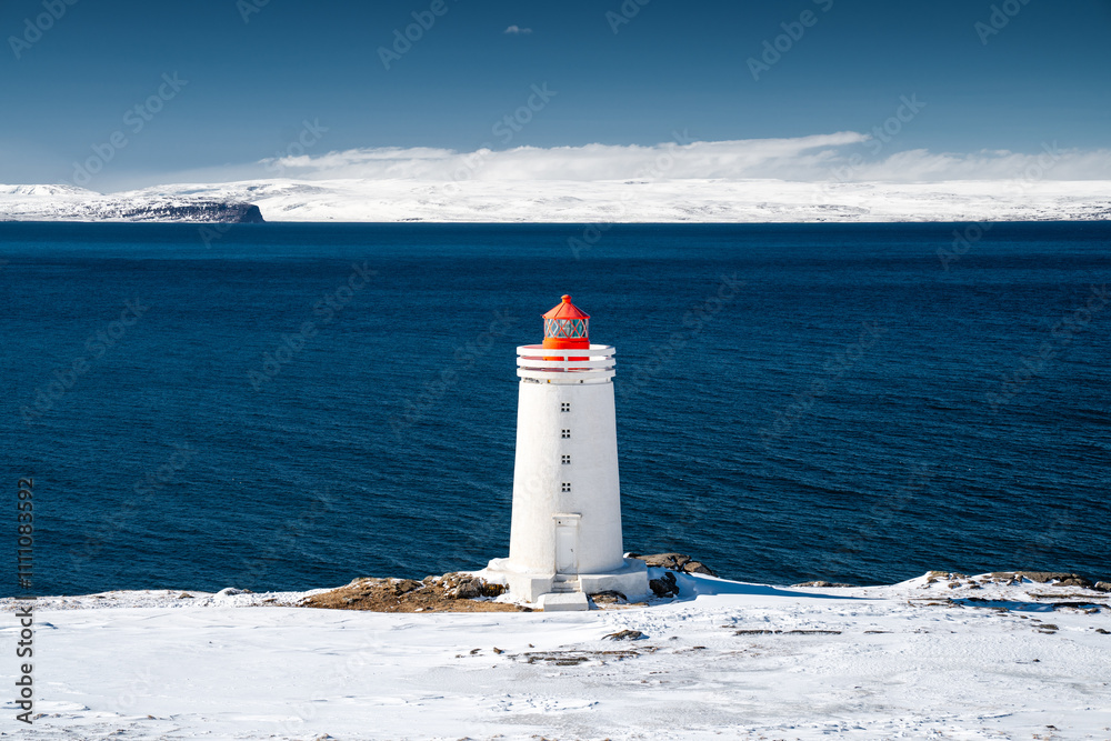 Lighthouse on Snowy Coastline
