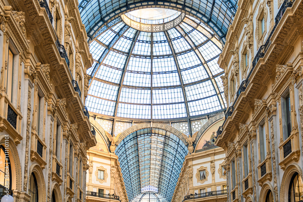 Ornate facade of Galleria Vittorio Emanuele II in Milan, Italy. Oldest Italian shopping mall neoclassical architecture with grand glass dome and decorative details in Milano city Ornate facade of Galleria Vittorio Emanuele II in Milan, Italy. Oldest Italian shopping mall neoclassical architecture with grand glass dome and decorative details in Milano city