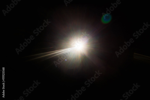 Easy to add lens flare effects for overlay designs or screen blending mode to make high-quality images. Abstract sun burst, digital flare, iridescent glare over black background.