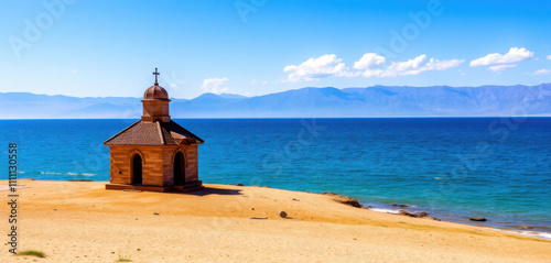 A serene and solitary Kaptavank Chapel, situated beside the tranquil shores of Lake Sevan, with its vast expanse of crystal blue waters gently lapping at the shore. photo