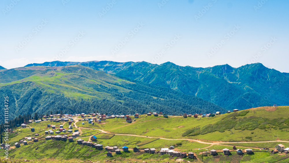 Sunny view of green hills and a mountain village Sunny view of green hills and a mountain village